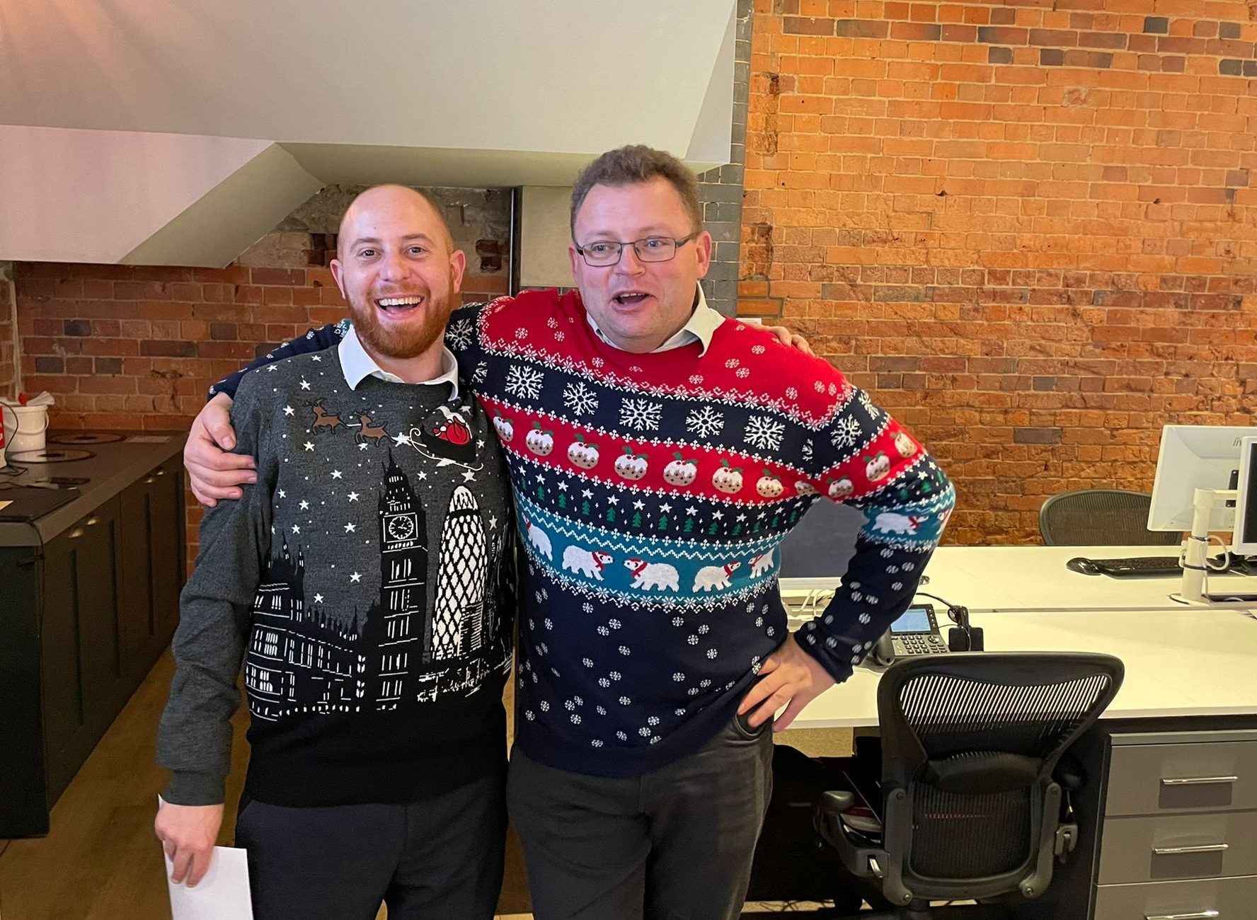 two happy men wearing christmas jumpers together at haslams